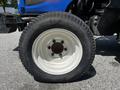 Front tire of a 2018 New Holland Boomer 45 tractor featuring a white rim and rugged black tread labeled Journey