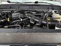 The image shows the engine compartment of a 2012 Ford F-550 with various components including hoses wires and a large black air intake manifold