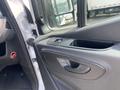 A close-up view of the door panel of a 2025 Mercedes-Benz Sprinter showing the handle and control buttons