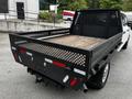 A 2020 Ford F-350 SD with a flatbed truck design features a black metal frame and a wooden cargo area with slatted sides