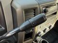 Close-up of a 2012 Dodge Ram 5500 gear shifter with buttons for shifting gear positions and volume controls on the dashboard