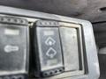 Close-up of two control switches with symbols for different functions on a John Deere 350 heavy machinery console