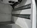 The interior of a 2019 Ford Transit Connect showing metal rails along the walls for securing cargo on a metal floor