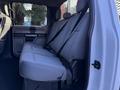 Interior view of the rear seating area of a 2020 Ford F-350 with gray fabric seats and seat belts