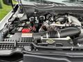 Close-up of the engine compartment of a 2021 Ford F-550 showcasing various components including the air intake and battery