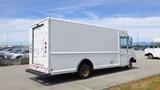 A white 2011 Ford Econoline van with a fixed rear cargo door and no visible branding parked in an outdoor lot