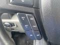 Close-up of the control buttons on the steering wheel of a 2017 Ford F-550 including options for setting and canceling cruise control