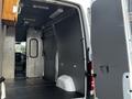 Interior view of a 2017 Mercedes-Benz Sprinter van showing empty cargo space with metal walls and a partition door