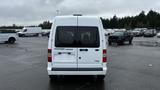 A white 2012 Ford Transit viewed from the rear with a blank license plate and no visible markings on the back doors