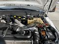 Engine compartment of a 2011 Ford F-450 SD featuring various components including hoses battery and coolant reservoir