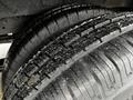 Close-up of two black tires showing deep tread patterns and small debris on the surface