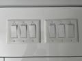 A set of light switches on a white wall including options for LED lights with labels for different functions and controls