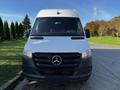 A 2022 Mercedes-Benz Sprinter van with a white exterior and prominent black front grille featuring the Mercedes-Benz logo