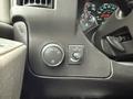 Controls on the dashboard of a 2014 GMC Savana including a knob for light settings and a switch for dome light operation