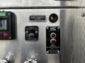 A control panel featuring various buttons and indicators for the pump system of a 2009 Spartan Gladiator including a pump overheat alarm and an indicator light