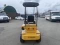 A 2024 AGT KRW 23 Mini loader in yellow with a black seat and canopy positioned at the rear facing forward with visible wheels and engine cover