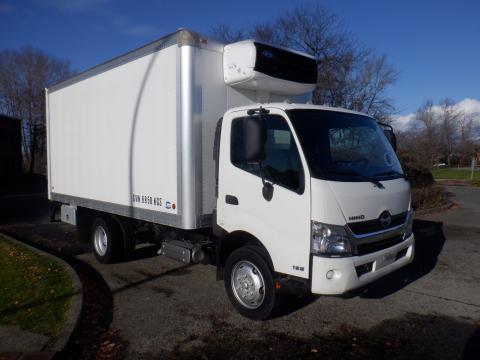 A 2015 Hino 195 truck with a white box cargo area and a refrigeration unit on top parked at an angle