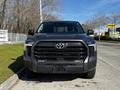 A 2023 Toyota Tundra in the foreground with a robust front grille and sleek headlights