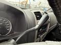 A close-up view of the dashboard of a 2012 GMC Canyon showing the speedometer and controls for the audio system and gear shift lever
