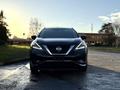A 2021 Nissan Murano with a sleek black exterior and distinctive front grille is positioned facing the viewer