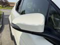 Close-up of the side mirror of a 2021 Toyota C-HR in white with a sleek design and integrated indicator light