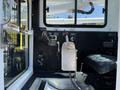 A 2014 Achiever DPM52MH featuring a black control panel with various levers and switches and a seat on the right side