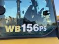 A close-up view of the cab window of a 2007 Komatsu WB156PS-5 with visible controls and a large label showing the model number WB156PS