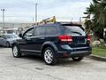 A 2013 Dodge Journey in dark blue with alloy wheels parked at an angle showcasing its rear and side profile
