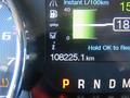A close-up view of the dashboard of a 2014 Ford F-150 showing the odometer reading 108225.1 km and various information display indicators