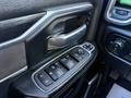 Close-up of the door control panel in a 2023 RAM 3500 featuring buttons for window and door lock controls