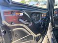 The image shows the interior door panel of a 2018 Kubota RTV XL 1100 C with various labels and a door handle