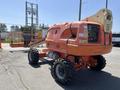 2008 JLG Boom Lift with an orange exterior large wheels and an extended arm ready for lifting equipment or workers at height
