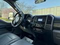 Interior of a 2020 Ford F-550 with a leather seat dashboard controls and a display screen
