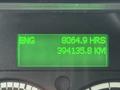 Display screen of a 2019 Freightliner M2 showing 8064.9 operating hours and 394135.8 kilometers logged