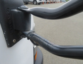 A close-up view of the side mirror and mount of a 2020 Chevrolet Express showing the mirror arm and attachment point