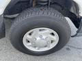 Close-up of a tire mounted on a silver wheel from a 2009 Ford Econoline with visible tread and a shiny rim