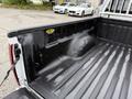 The image shows the bed of a 2012 GMC Canyon with a textured black liner and grooves running along the floor