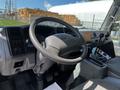 Interior view of a 2009 Ford LCF 550 showing a steering wheel dashboard and gear shifters