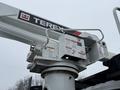 A Terex boom lift attachment mounted on a 2020 International MV607 truck showing control panels and safety labels