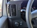 Close-up of the dashboard controls and air vent of a 2019 Chevrolet Express with knobs and buttons for various vehicle features