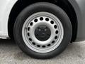 A close-up of a silver wheel with a black hubcap and tire marked Goodyear, featuring multiple circular holes in the design and a Mercedes-Benz logo