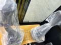 A pair of wrapped control levers for a 2024 AGT Industrial Yellow H13R Mini Excavator displayed on a control panel