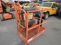A 2009 JLG E300AJP aerial work platform with an orange frame a control panel and a seat for the operator on a metal platform