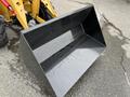A black bucket of a 2024 AGT Industrial KRW23 Mini Loader with a smooth interior surface and water droplets visible inside