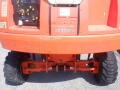 A 2008 JLG Boom Lift showing the rear view with large rubber tires and operational control panel visible on the back