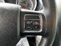 Close-up of the steering wheel controls of a 2011 Dodge Grand Caravan featuring buttons labeled ON/OFF RES CANCEL and SET
