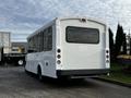 A white 2017 Chevrolet Express bus with large windows and a number 1248 displayed on the rear