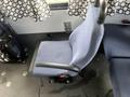 A blue fabric seat from a 2012 Chevrolet Express with armrests and a sturdy base