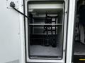 Interior view of a storage compartment in a 2013 Chevrolet Express with straps for securing items inside