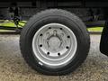 A close-up of a silver wheel with a black Aeolus tire featuring six lug nuts and a textured tread pattern